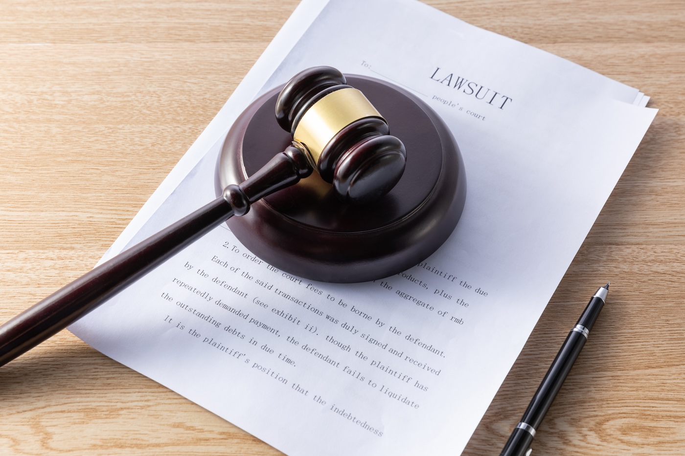 A selective focus shot of a gavel on documents - law concept