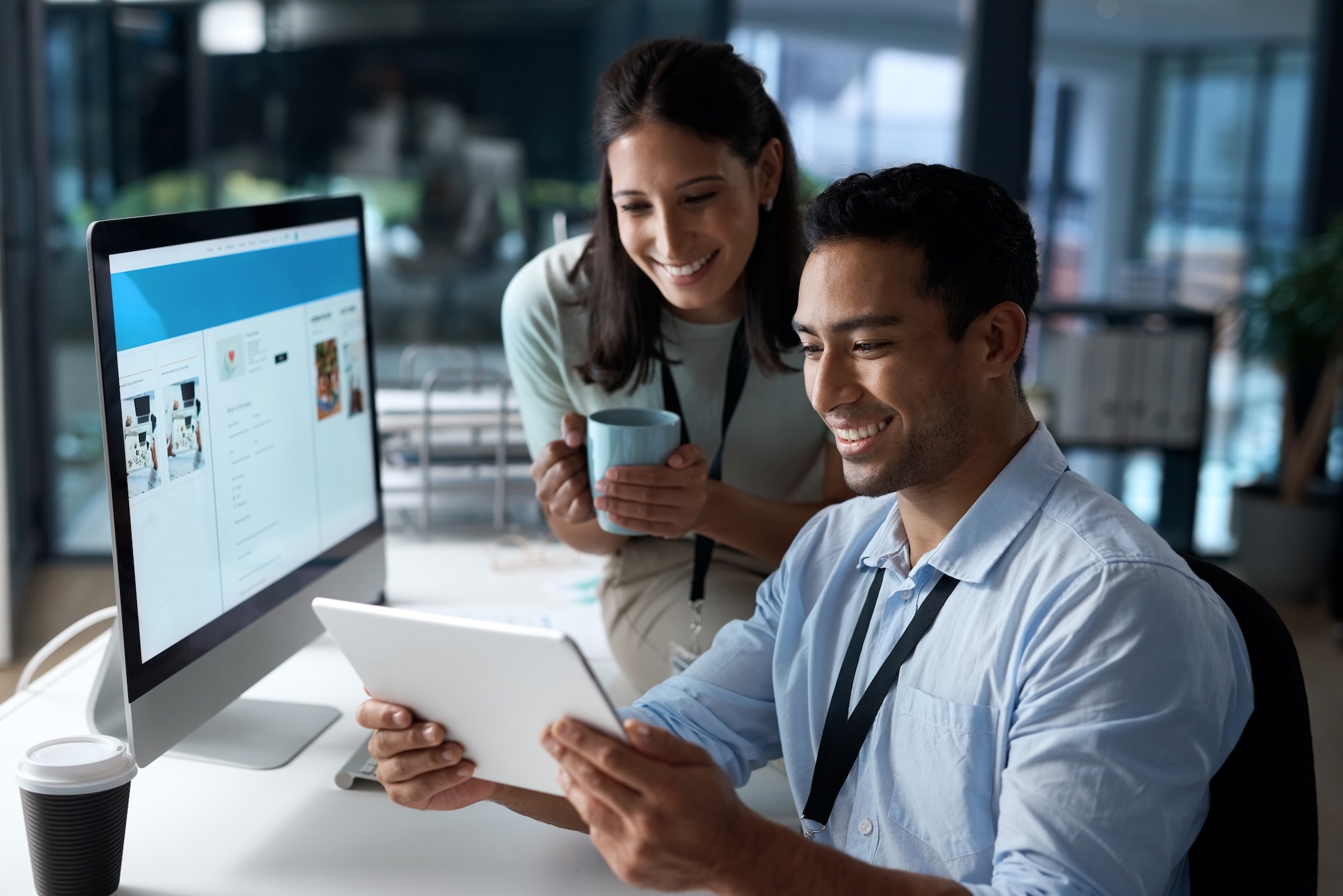 Shot of a young businessman and businesswoman using a digital tablet in a modern office.