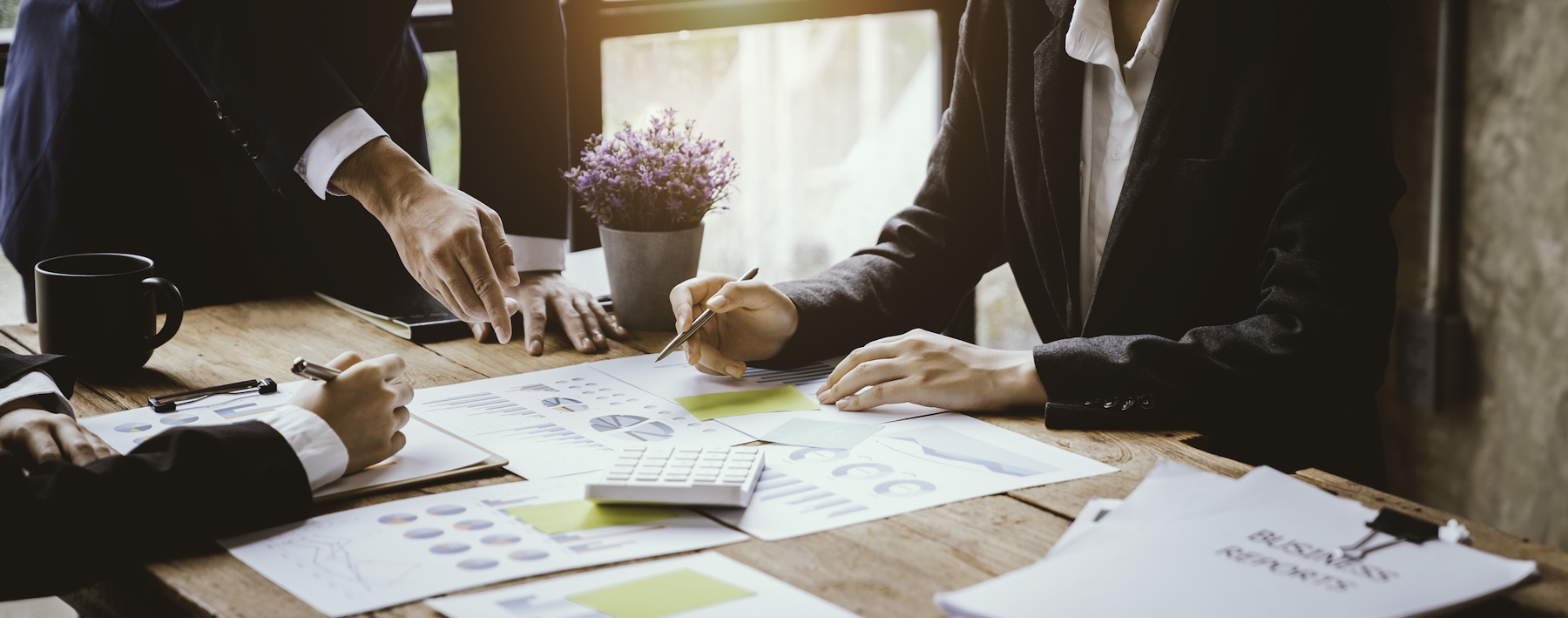 business-people-analyzing-charts-and-reports-at-work